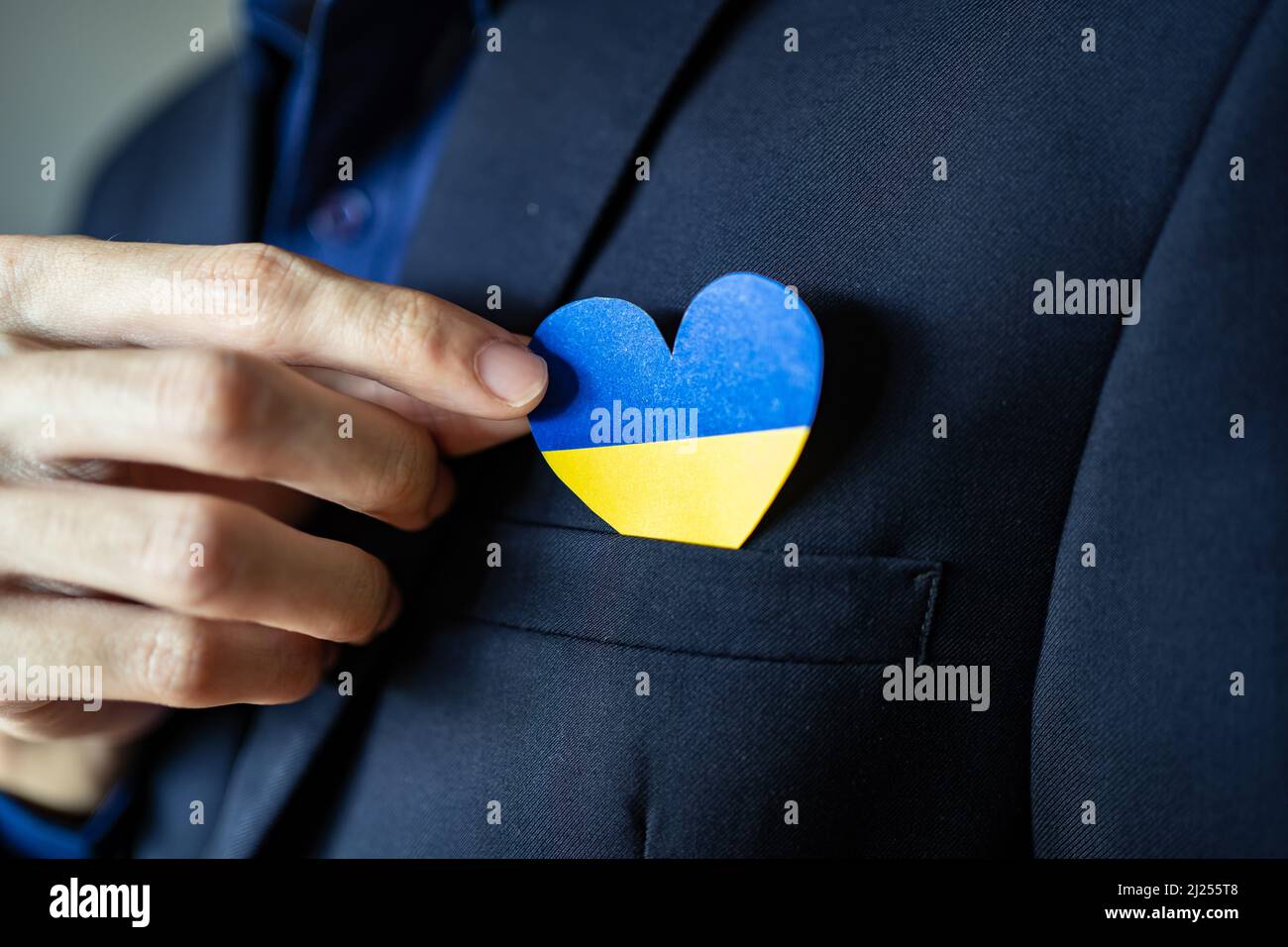 Ukraine flag color heart in suit pocket Stock Photo