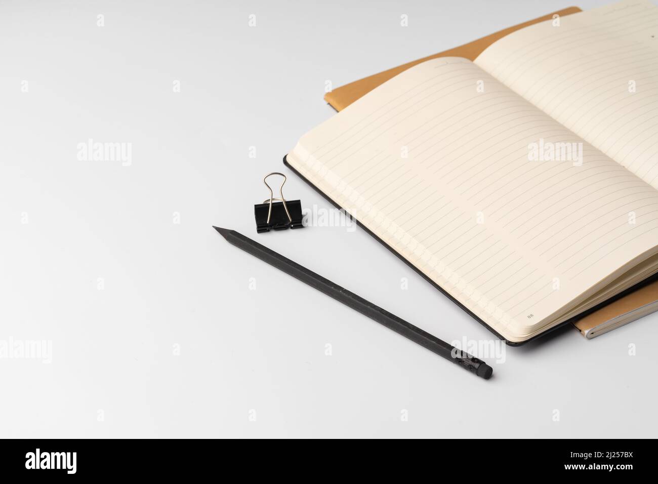 Open Notepad Book Blank open notepad and pen on white table, close up Stock Photo - Alamy