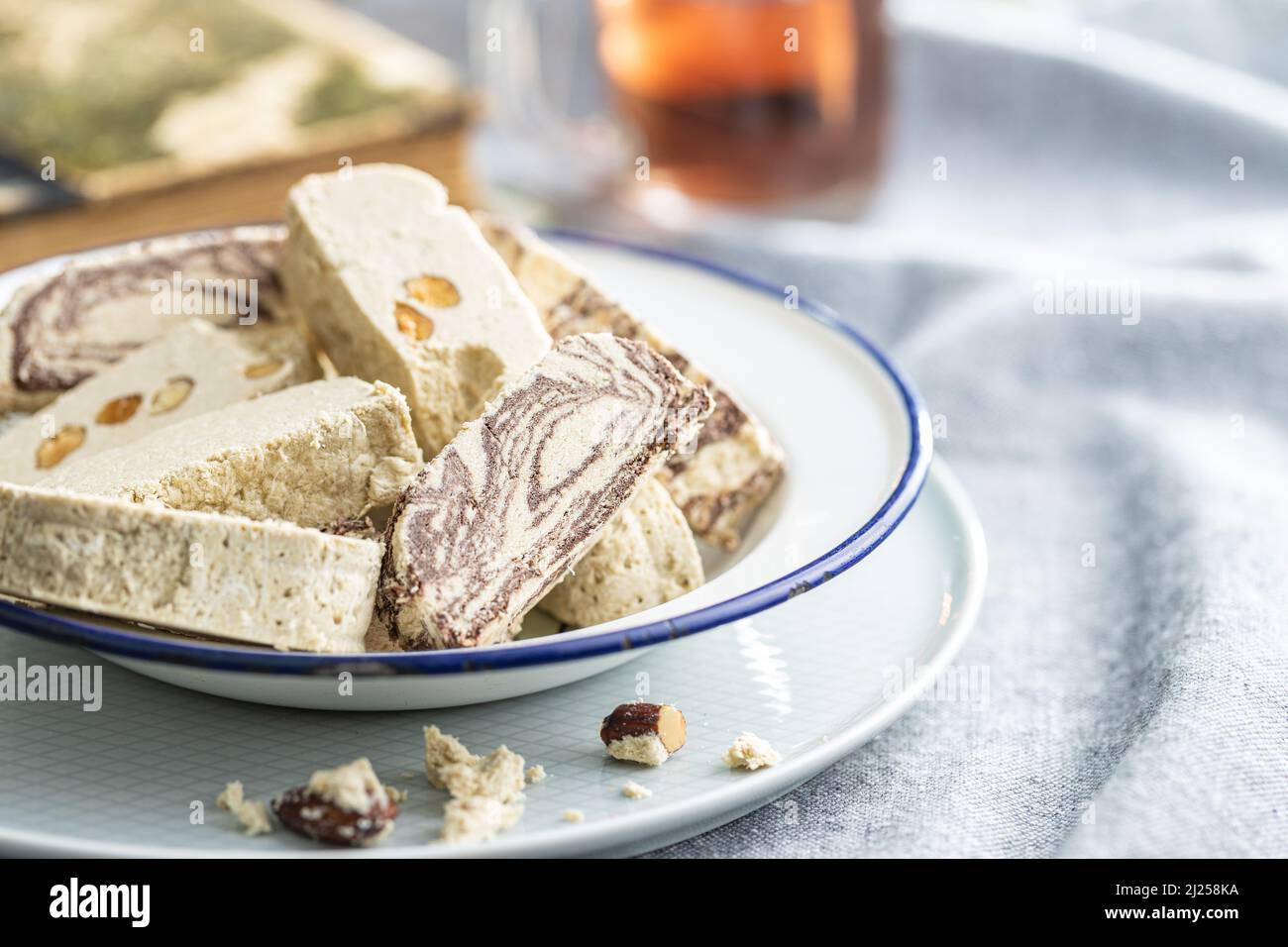 Sweet tahini halva with cocoa flavor and almonds. Turkish dessert on a