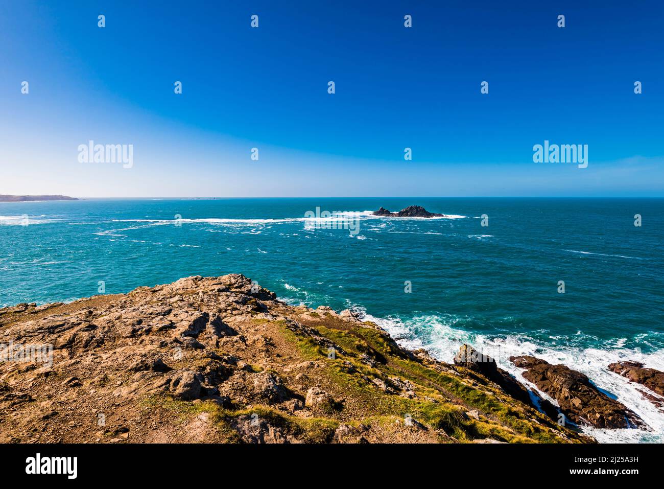 Land's End, the Longships Lighthouse and The Brisons rocks, looking from Cape Cornwall, near Land's End, Penzance, Cornwall, UK Stock Photo