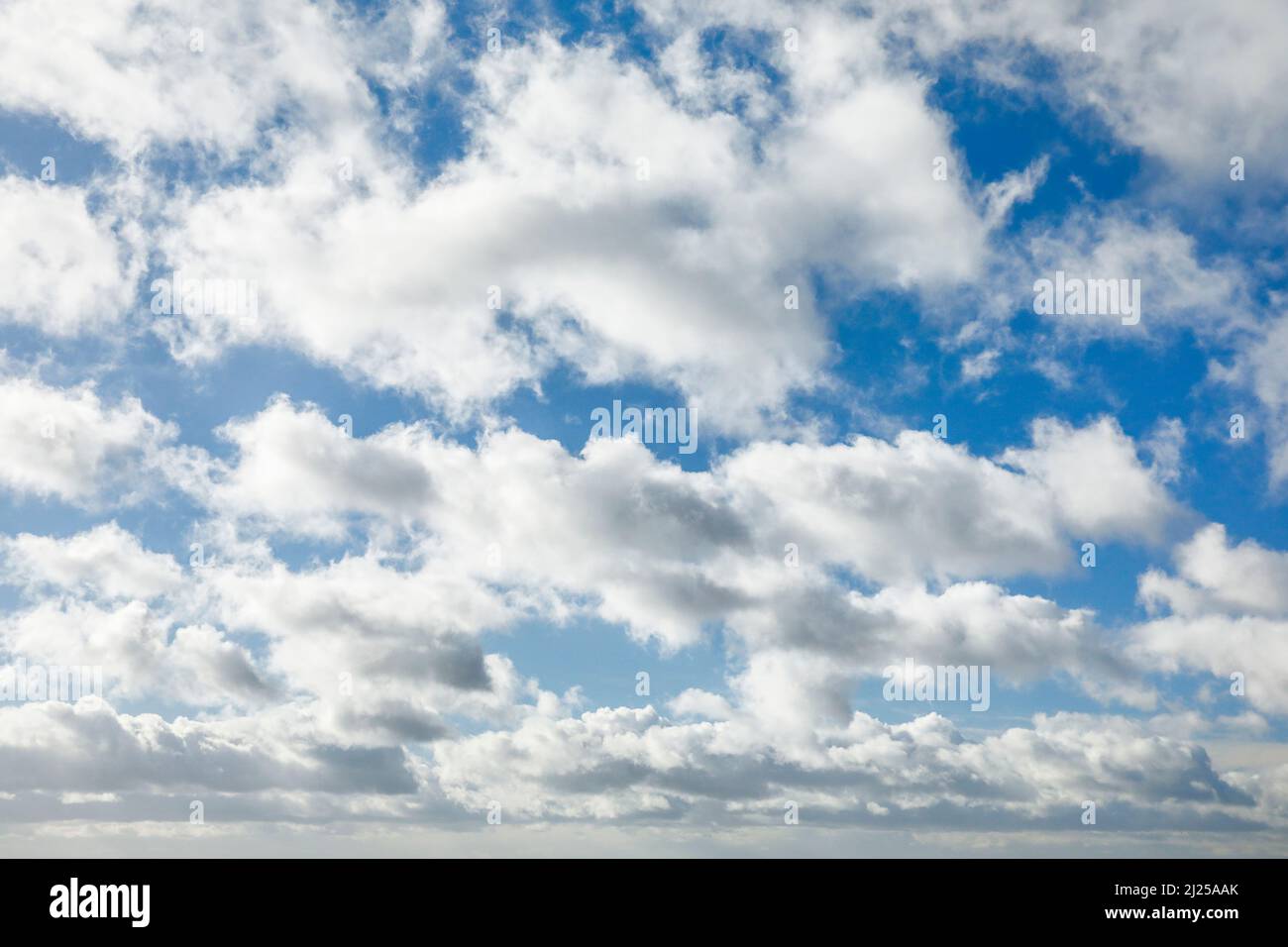 Cirrocumulus, Cirrostratus and (Stratocumulus)clouds adorn the blue sky in strong winds. Switzerland Stock Photo