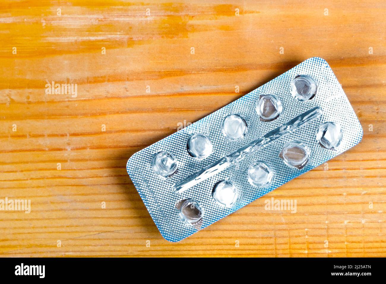 Empty Pack of the Pills on the Wooden Planks Background closeup Stock Photo
