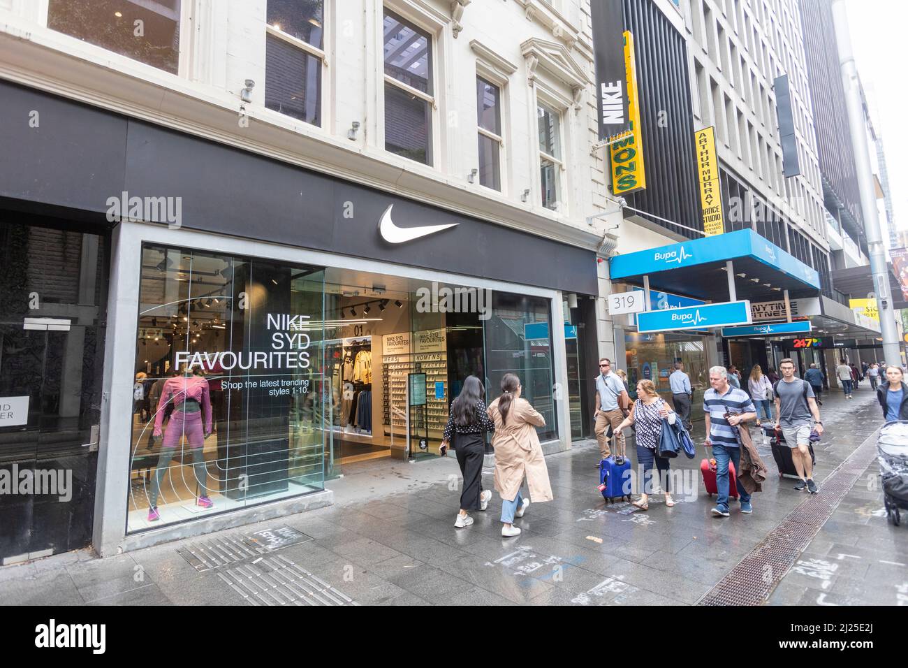 Nike store in Sydney city centre with BUPA health office ne Stock Photo -  Alamy
