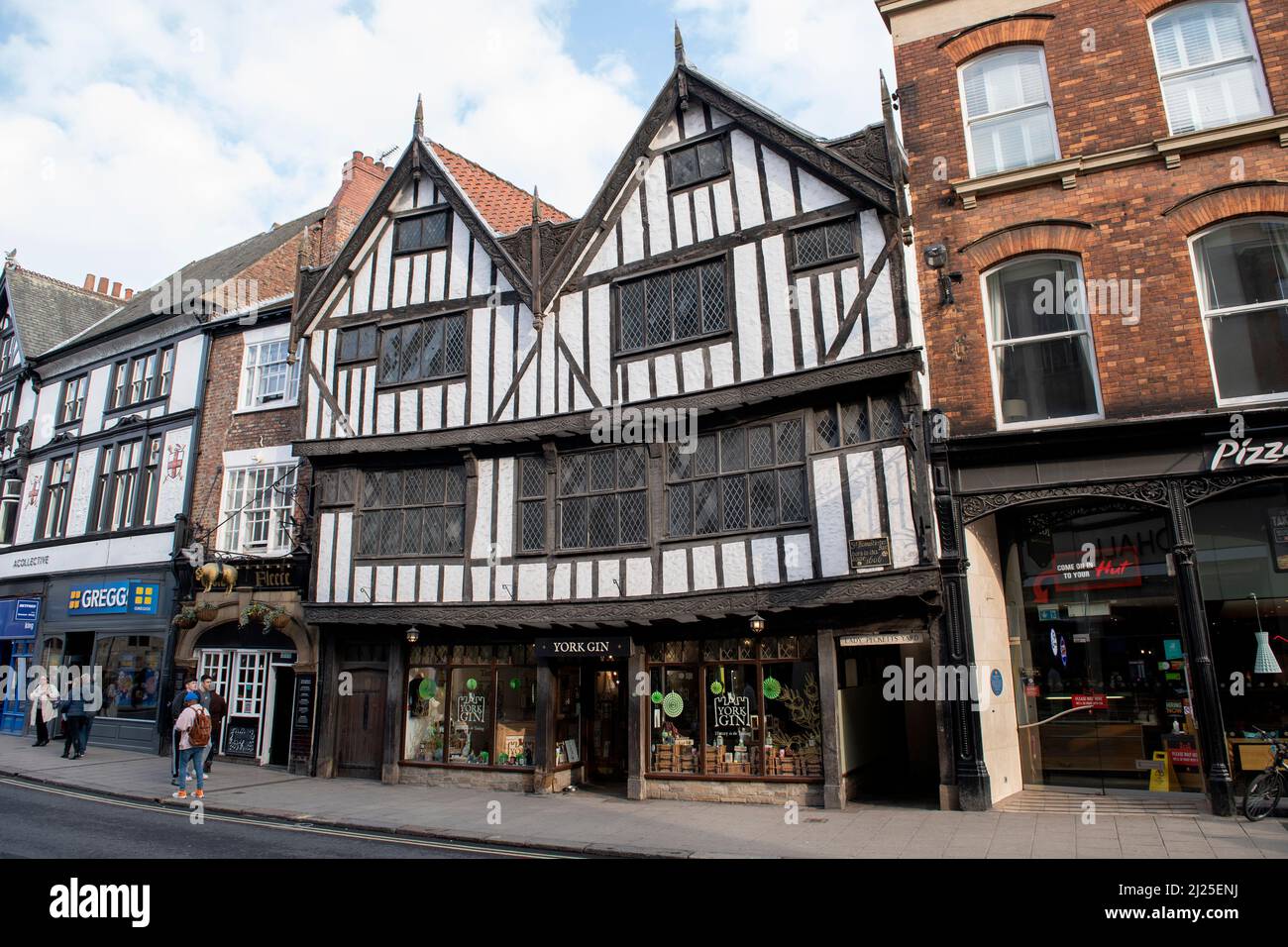 A 17th century building home to York Gin Shop below and the entrance to Lady Pecketts Yard at the side. Stock Photo