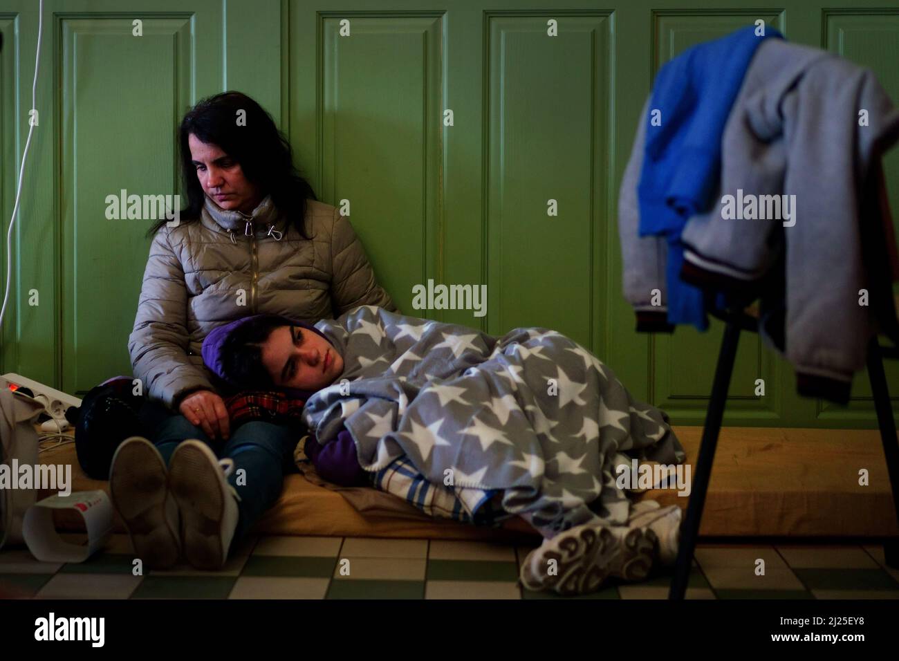 a-ukrainian-woman-and-her-child-rest-in-a-refuge-room-at-przemysl