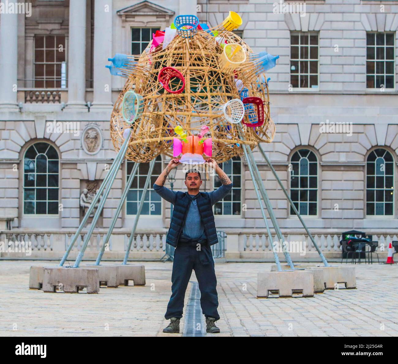 London UK 30 March 2022 Somerset House presents  The Arks of Gimokudan by the brilliant Philippine artist Leeroy New, which will be on view until 26 April to mark the occasion of Earth Day. This will be New’s first UK installation, and takes form as three fantastical upturned ships, elevated metres from the ground, constructed using plastic waste and recycled materials. The installation draws on the culture and mythologies of the artist’s home nation of the Philippines, a country at the frontline of the climate emergency. Paul Quezada-Neiman/Alamy Live News Stock Photo