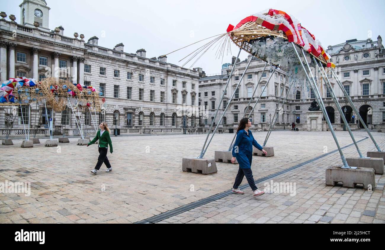 London UK 30 March 2022 Somerset House presents  The Arks of Gimokudan by the brilliant Philippine artist Leeroy New, which will be on view until 26 April to mark the occasion of Earth Day. This will be New’s first UK installation, and takes form as three fantastical upturned ships, elevated metres from the ground, constructed using plastic waste and recycled materials. The installation draws on the culture and mythologies of the artist’s home nation of the Philippines, a country at the frontline of the climate emergency. Paul Quezada-Neiman/Alamy Live News Stock Photo