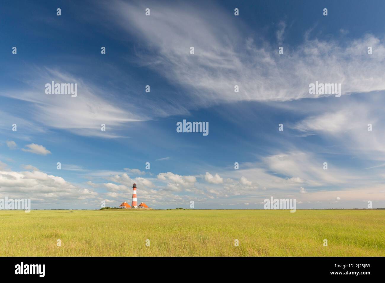 Westerhever lighthouse with clouds. Wadden Sea National Park, North Frisia, Schleswig-Holstein, Germany Stock Photo