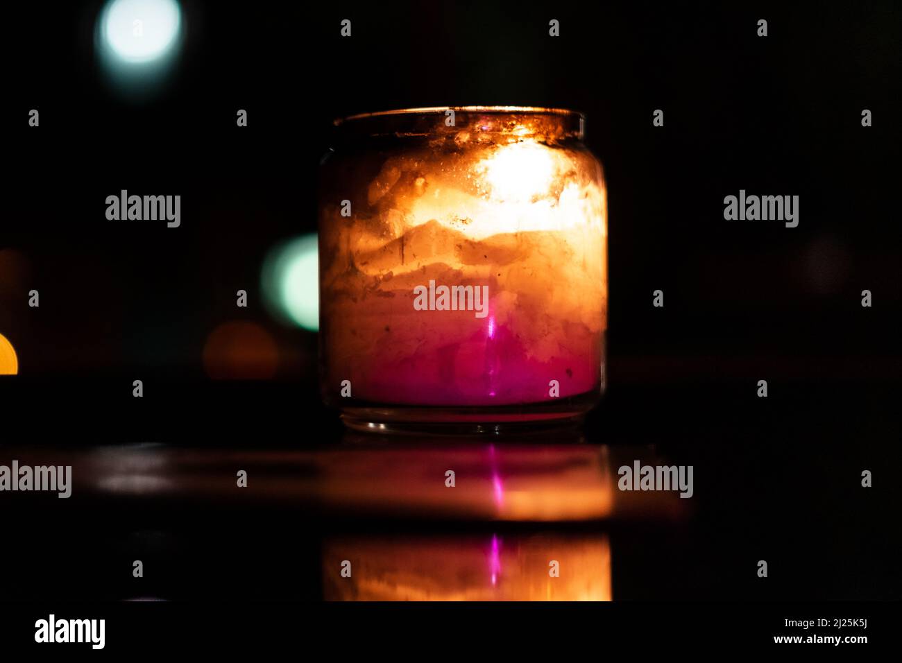 Glass candle with its reflection Stock Photo - Alamy