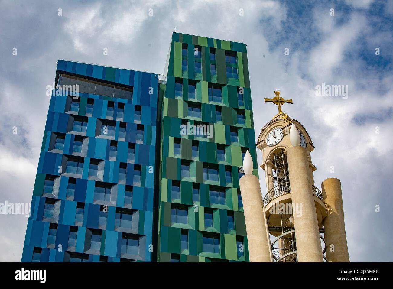 Orthodox cathedral clock tower and contemporary building, Tirana, Albania. Stock Photo