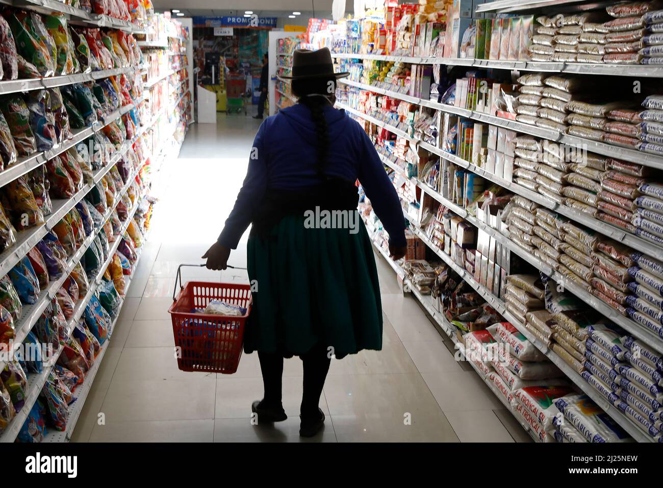 Indigenous woman shopping in a supermarket in Cuenca, Ecuador Stock