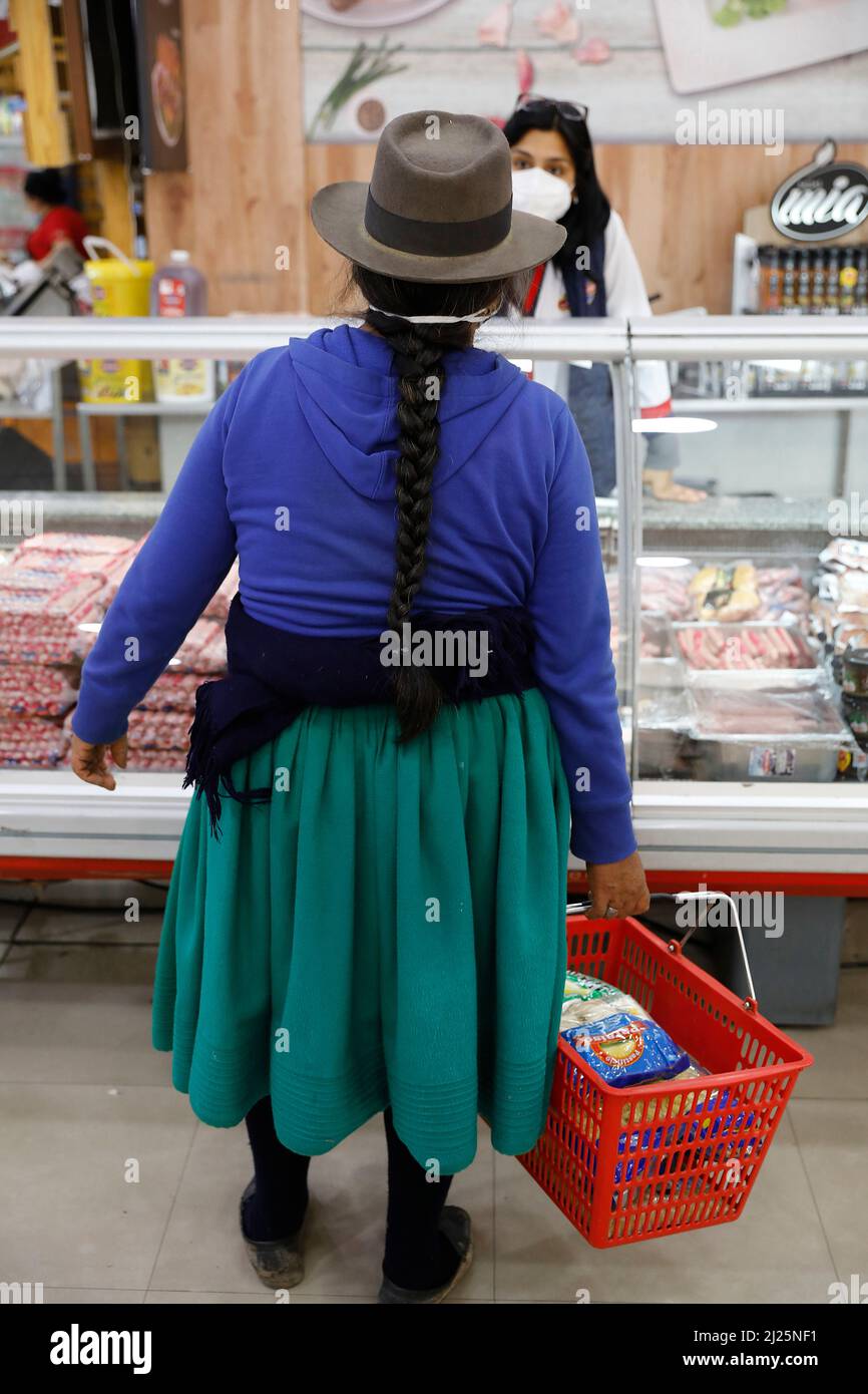 Indigenous woman shopping in a supermarket in Cuenca, Ecuador Stock