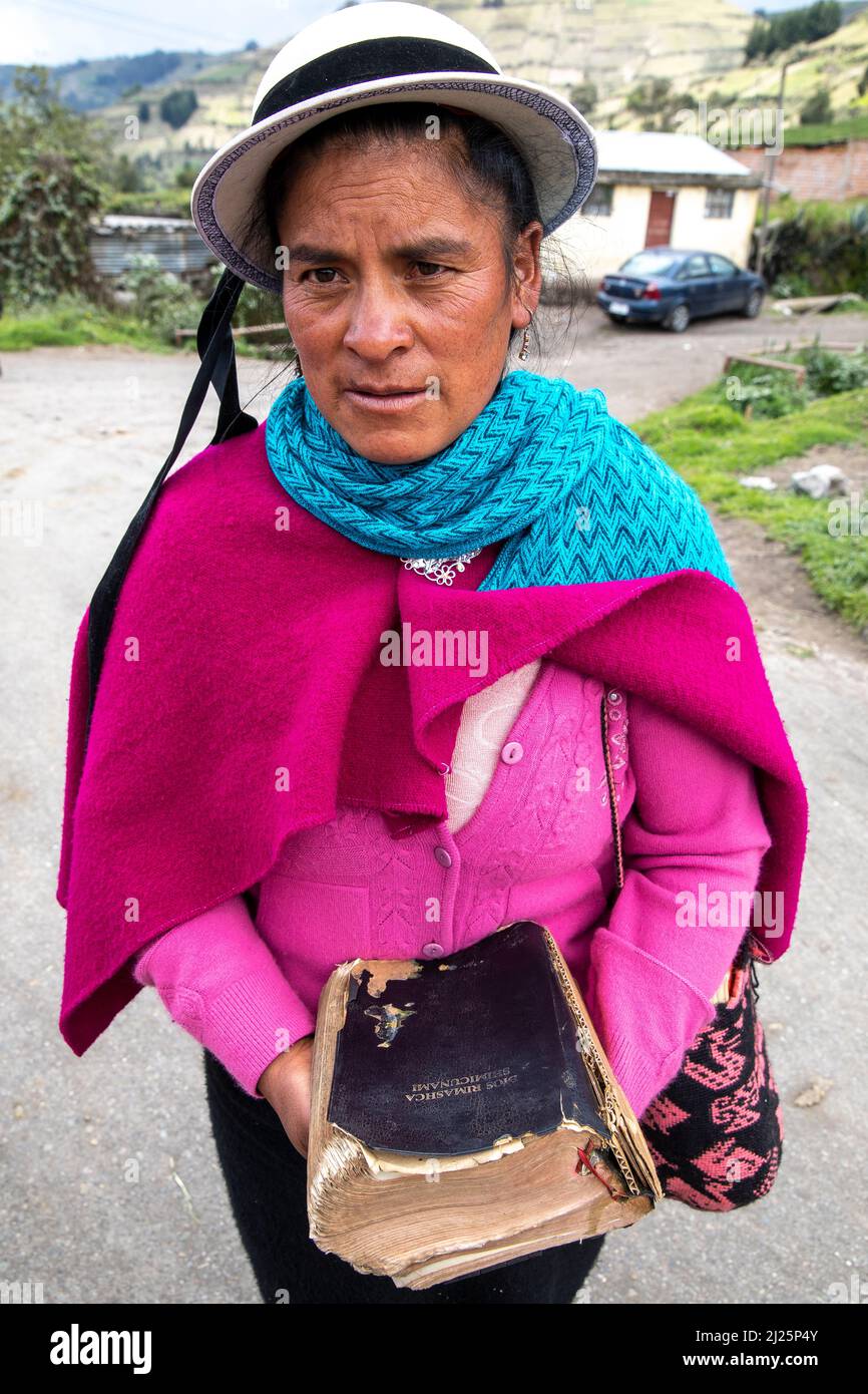 Ecuadorian woman carrying a bible in a Chimborazo village, Ecuador Stock Photo