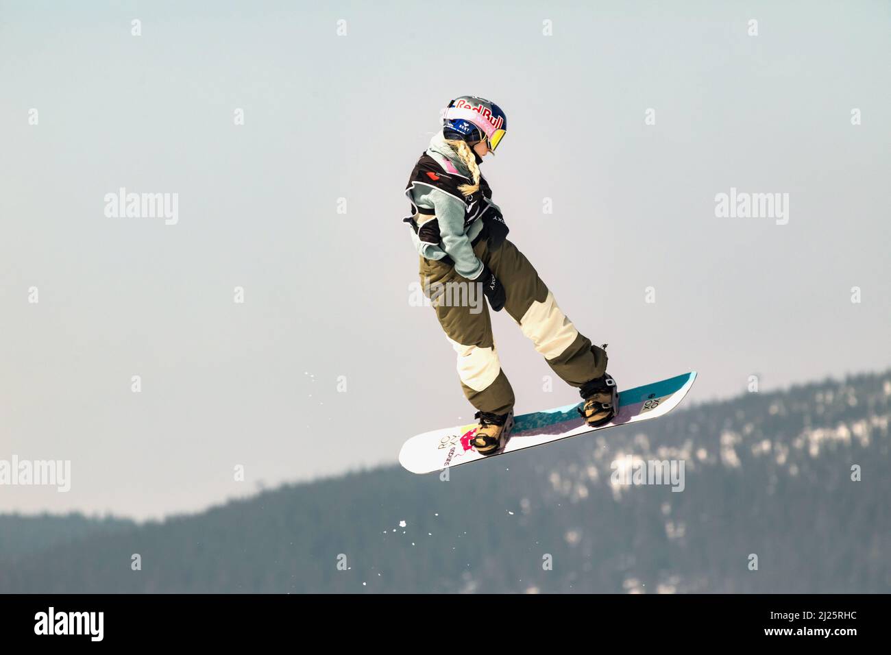 SPINDLERUV MLYN, CZECH REPUBLIC - 18th March. 2022: Snowboarder jumping against blue sky. Snowboarding. A young snowboarder jumps in the Spindleruv Ml Stock Photo
