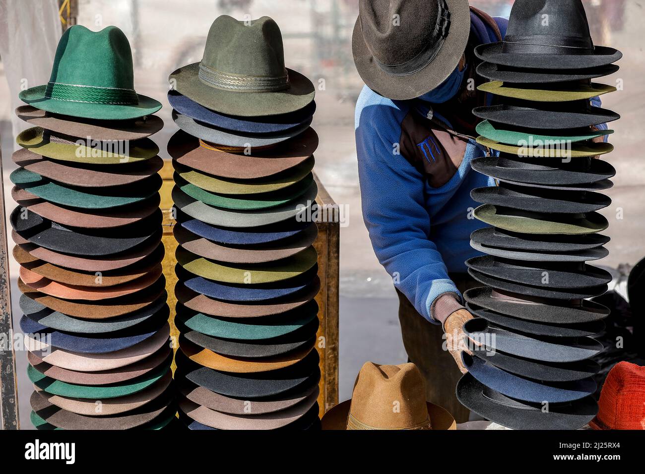 Man selling hats at the weekly market in the center of Riobamba