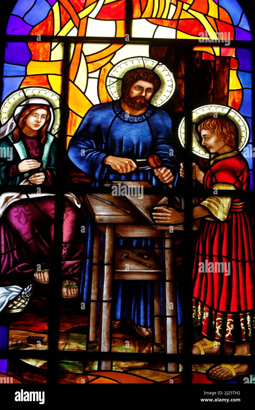 Almudena Cathedral. Stained glass window. Holy family. Joseph the carpenter with Jesus. Stock Photo