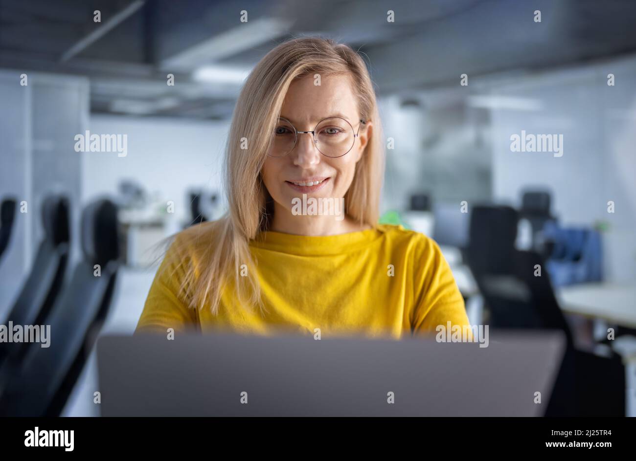 Woman working on laptop at office Stock Photo