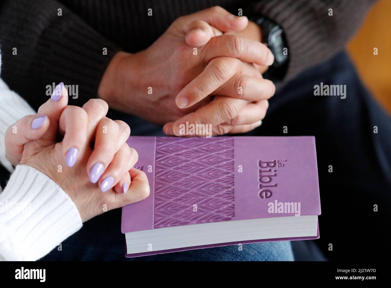 Man and woman reading and praying the bible. Bible study. Stock Photo