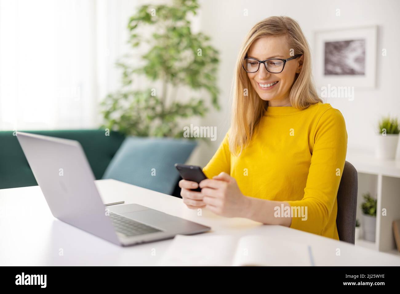 Woman using laptop smartphone hi-res stock photography and images - Alamy