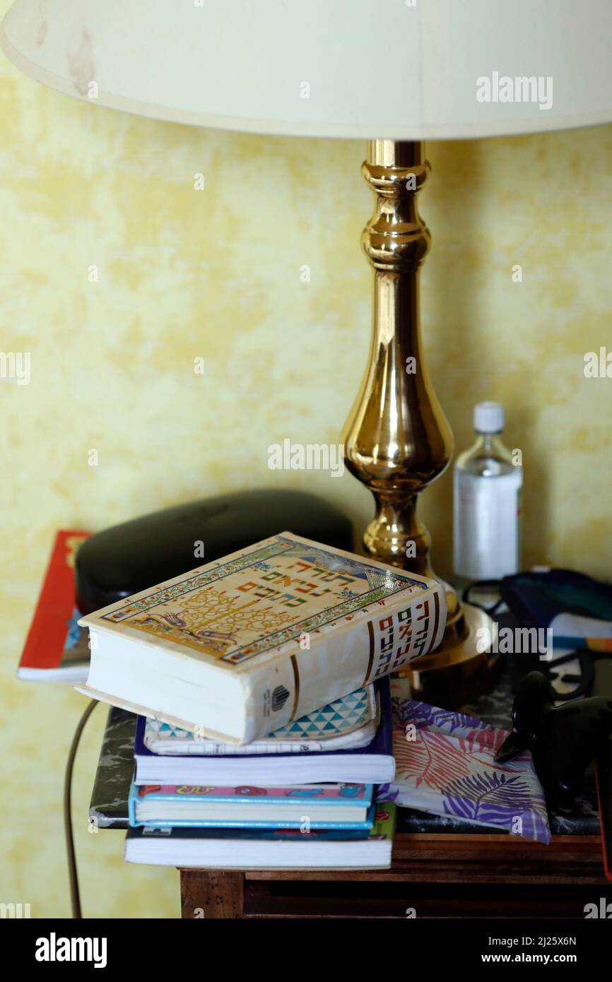 Religion at home. Hebrew Torah book on a bedside table beside a bed in