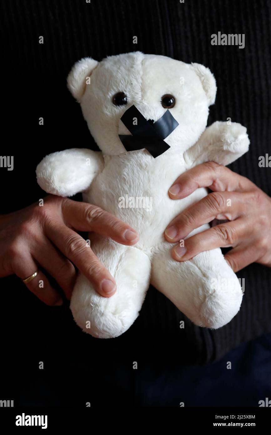Bear with tape on his mouth. Symbol of silence on child sexual abuse in the church. Stock Photo