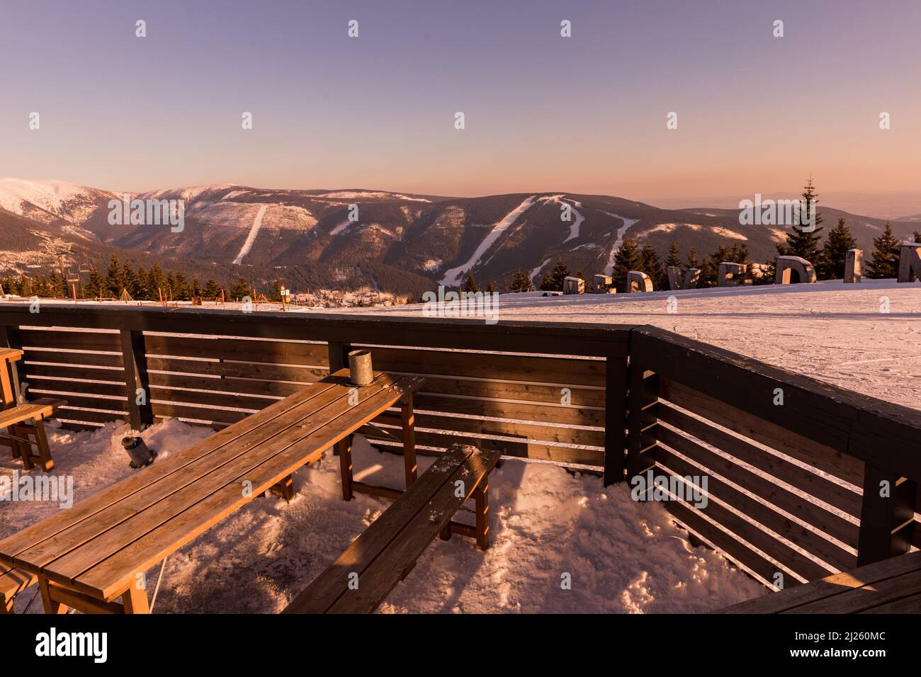 View from the terrace on the ski slopes Hromovka and Plane from the top of Medvedin mountain in the Giant Mountains in Bohemia at sunset. Stock Photo