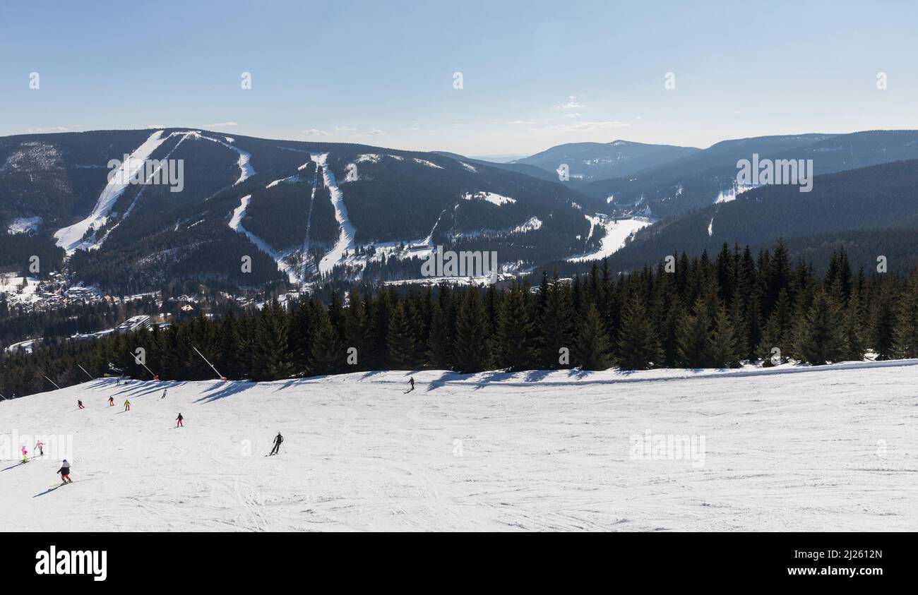 View of the ski resort Spindleruv Mlyn in mountain Krkonose from the top of Medvedin hill. Winter ski resort Spindleruv mlyn, slopes Plane and Hromovk Stock Photo