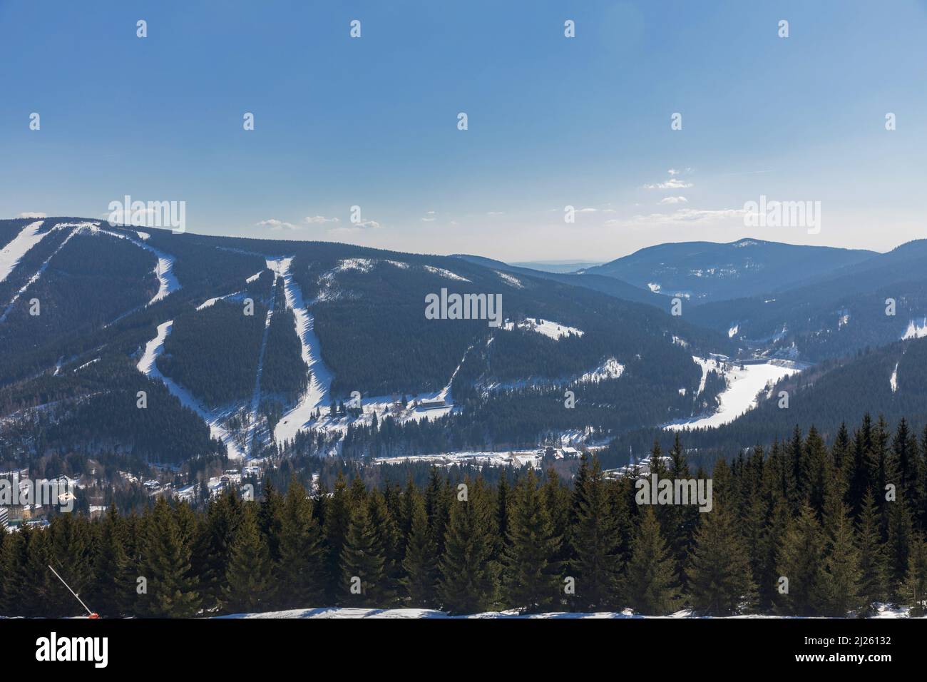 View of the ski resort Spindleruv Mlyn in mountain Krkonose from the top of Medvedin hill. Winter ski resort Spindleruv mlyn, slopes Plane and Hromovk Stock Photo