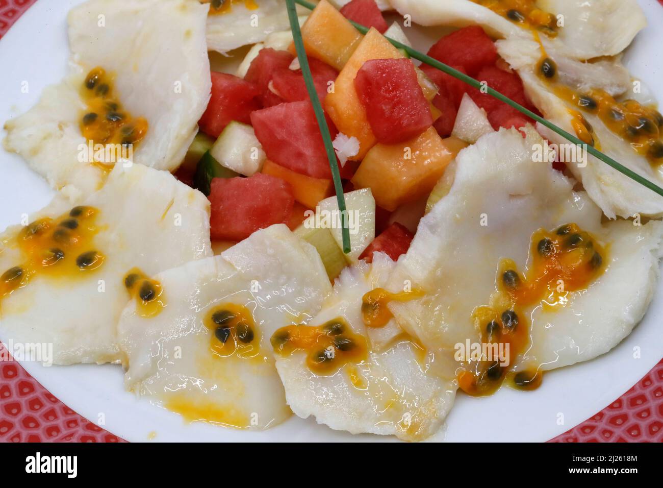 Asian kitchen. Scallops carpaccio with mango and passion fruits Stock Photo Alamy