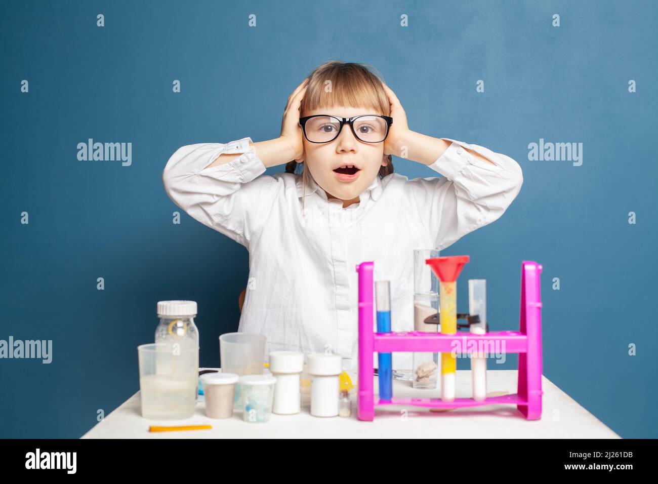 Shocked little girl school student and science experiments in school