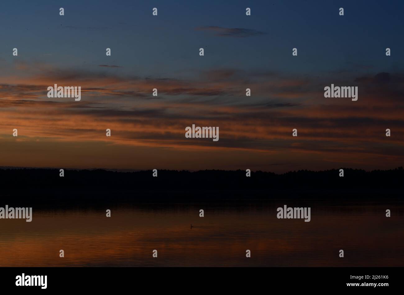 Beautiful sunset reflected in the lake Stock Photo - Alamy