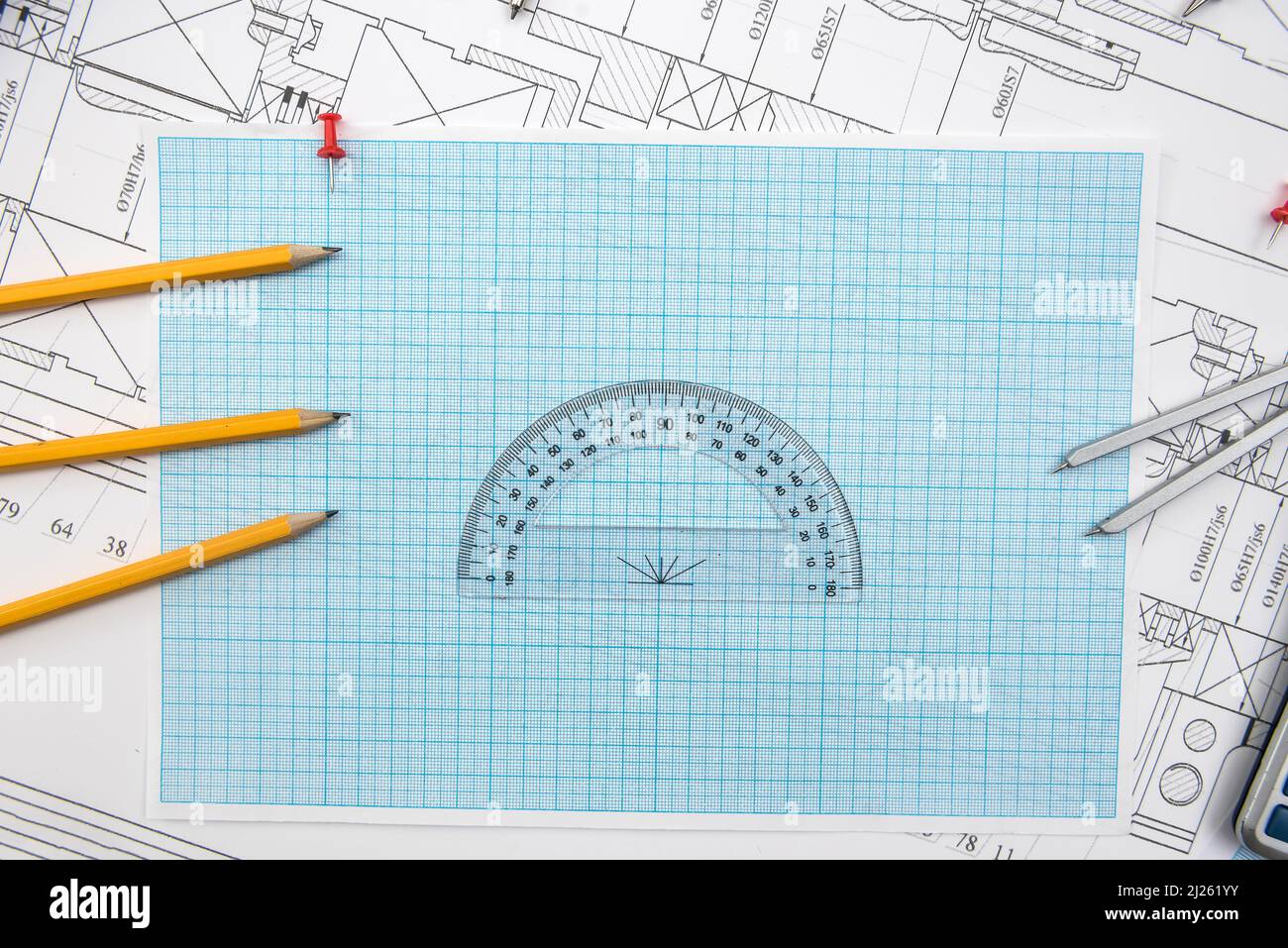Technical drawing, graph paper and tools. Engineer  office team working with blueprints. Stock Photo