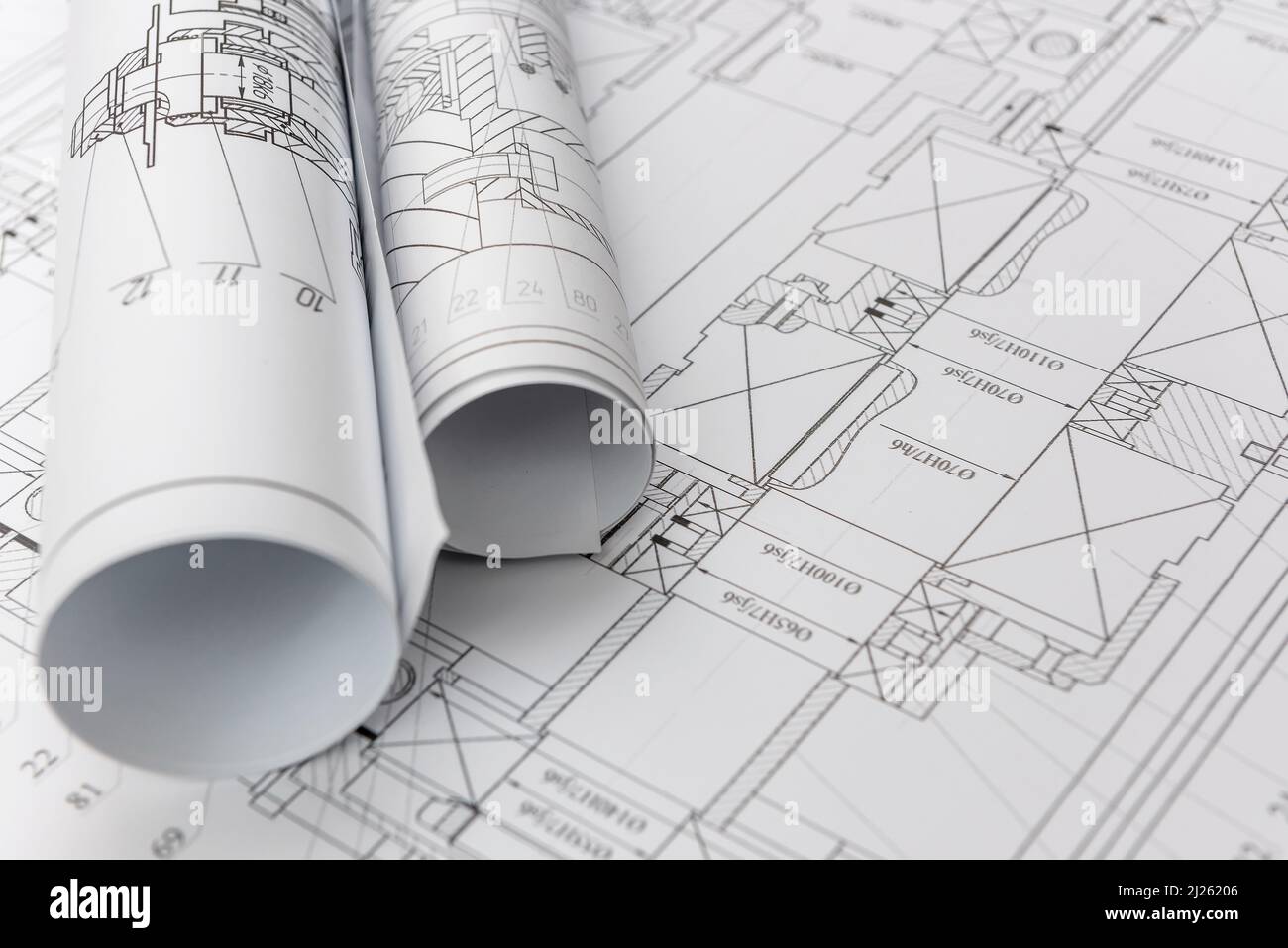 Technical drawings with blueprints in rolls close up. Engineering concept Stock Photo