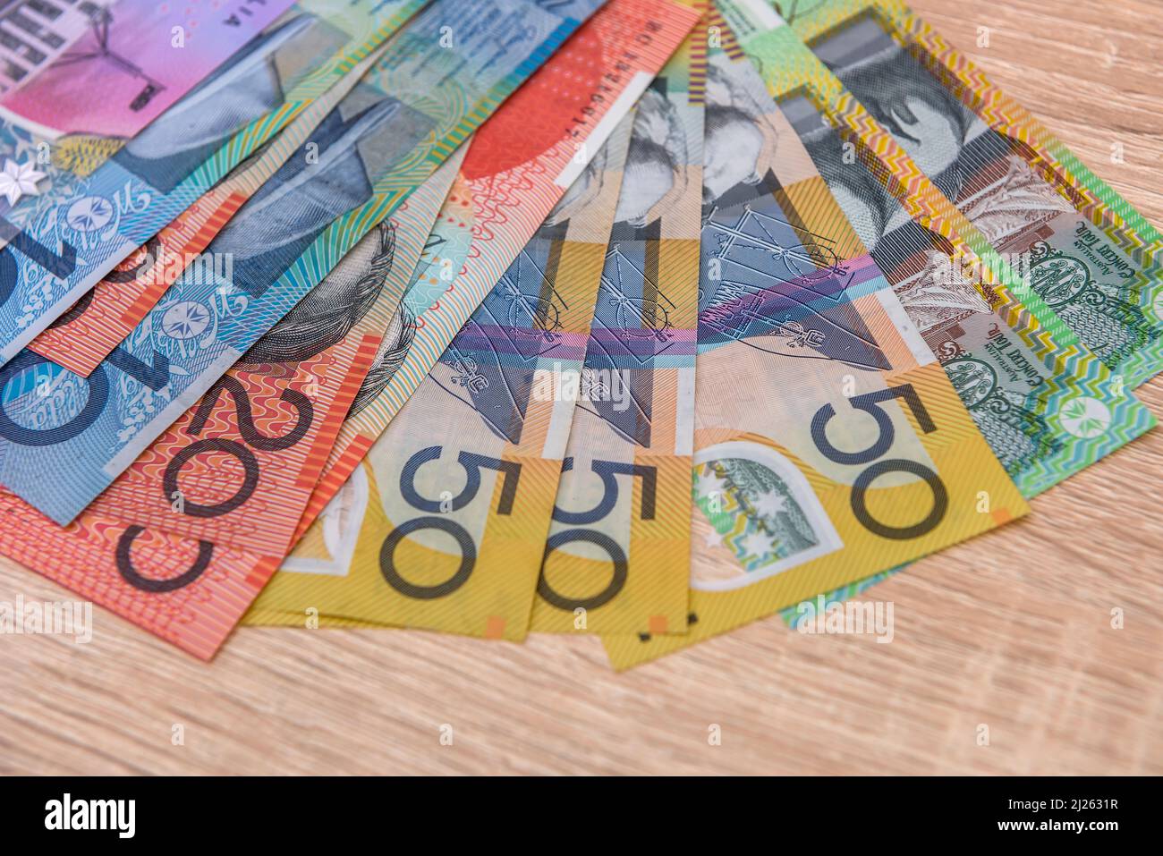 National currency. Colorful australian dollar banknotes on wooden table close up Stock Photo