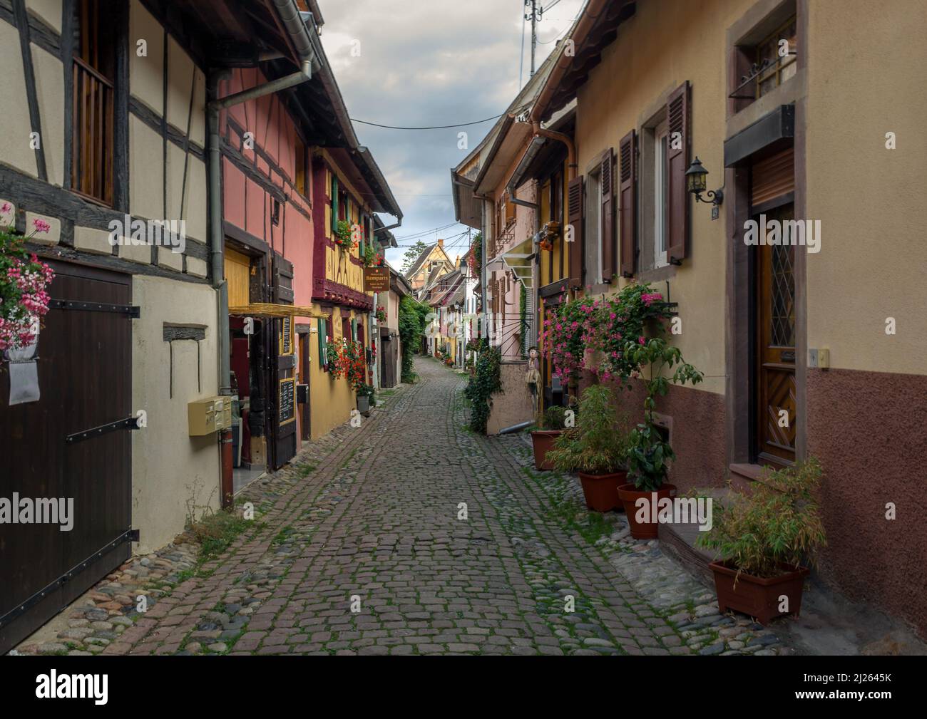 ancient alley in Eguisheim with cobbelstones Stock Photo