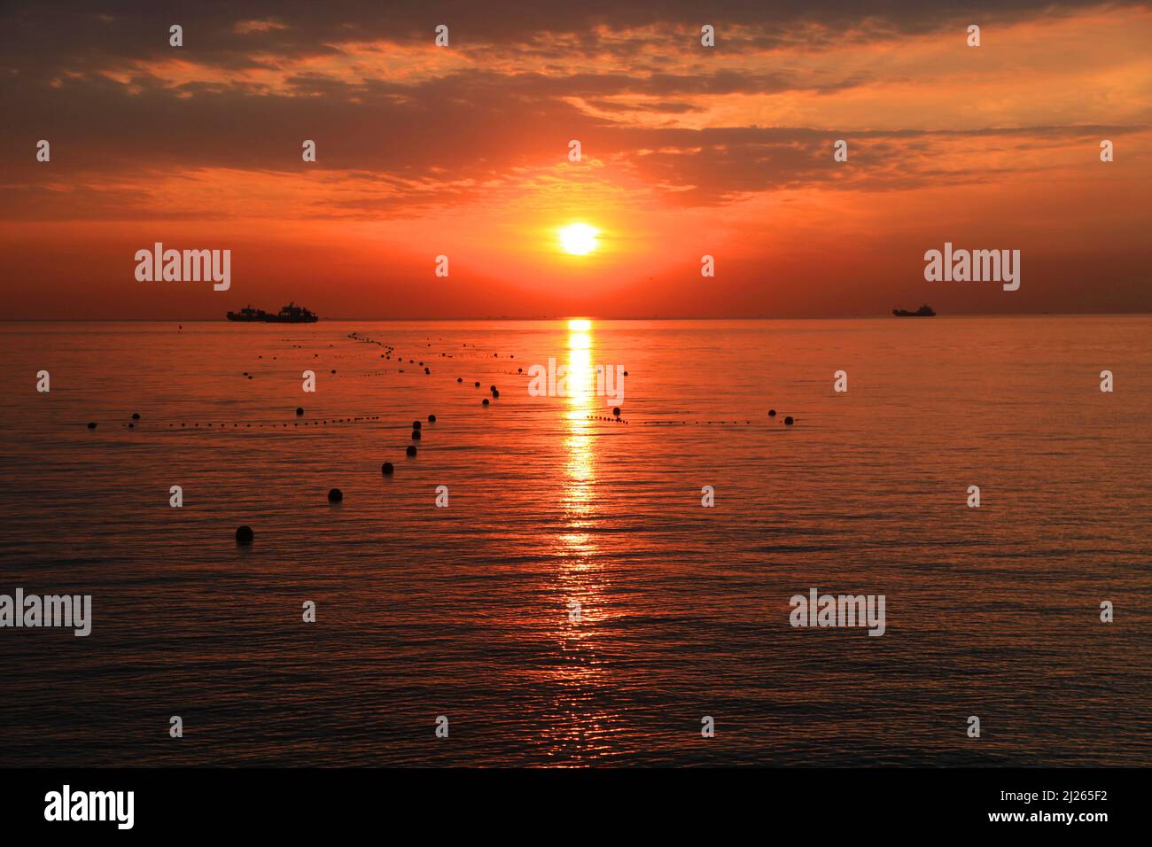 A beautiful scenery of the sunset reflecting on the ocean on a cloudy ...