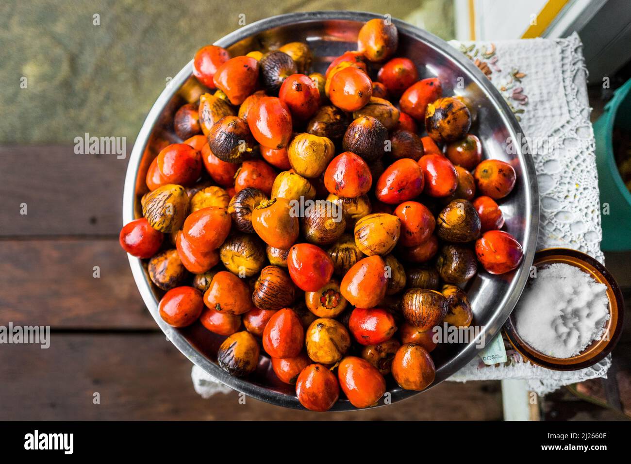 Freshly cooked chontaduro (peach palm) fruits are seen offered for sale in front of a house in Quibdó, Chocó, Colombia. Stock Photo