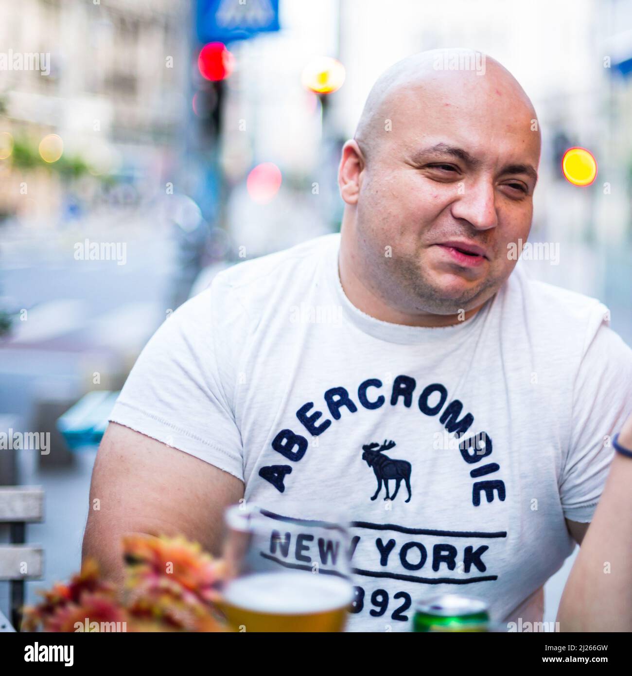 young-man-at-restaurant-table-in-bucharest-romania-2022-stock-photo