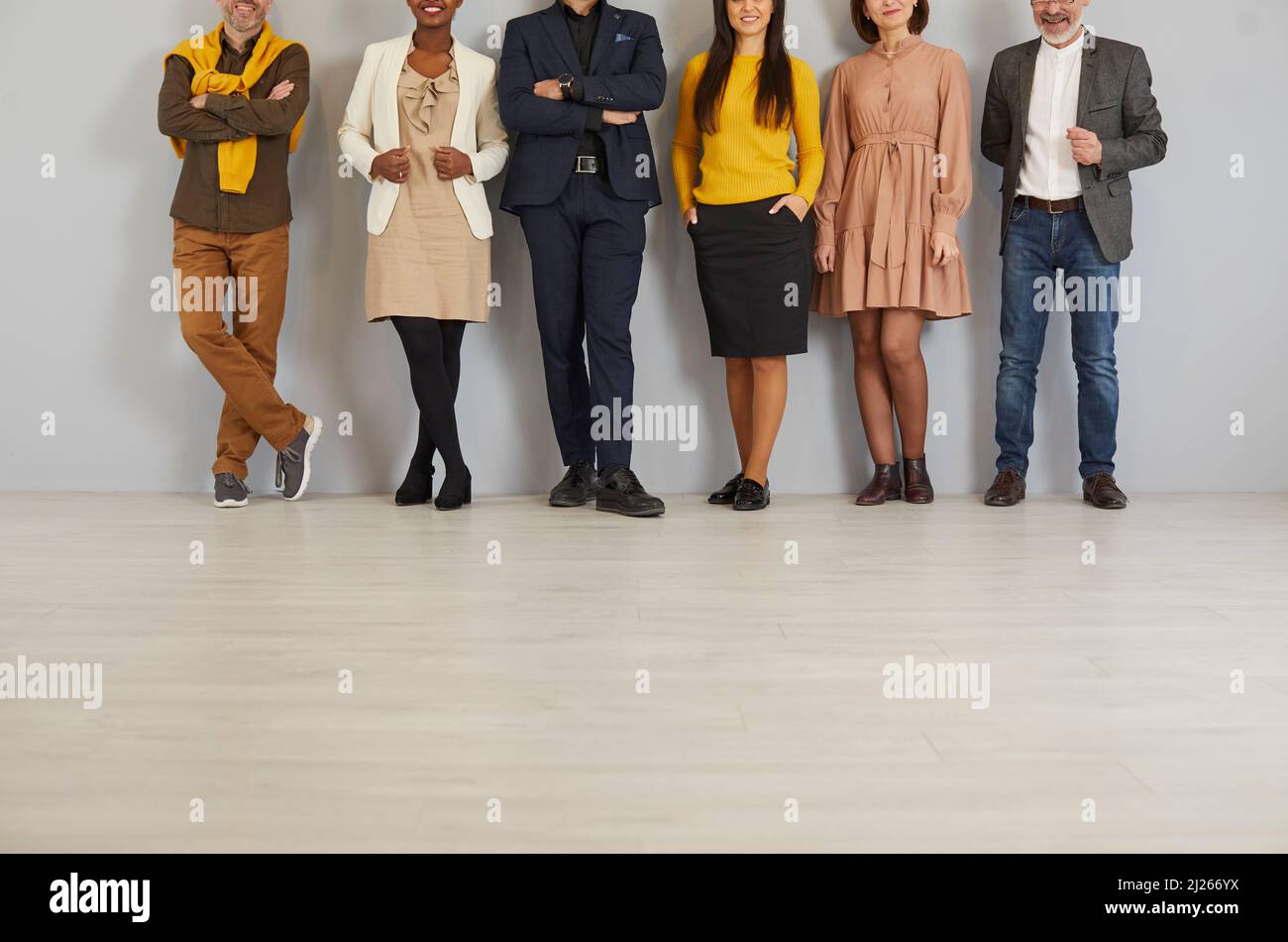 Group of different men and women wearing smart casual clothes standing in office Stock Photo