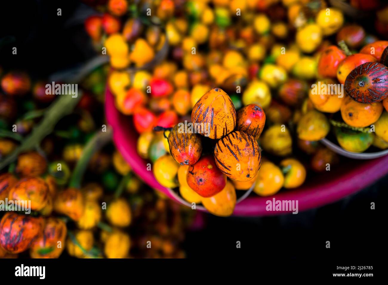 Raw chontaduro (peach palm) fruits are seen offered for sale in a street market in Quibdó, Chocó, Colombia. Stock Photo