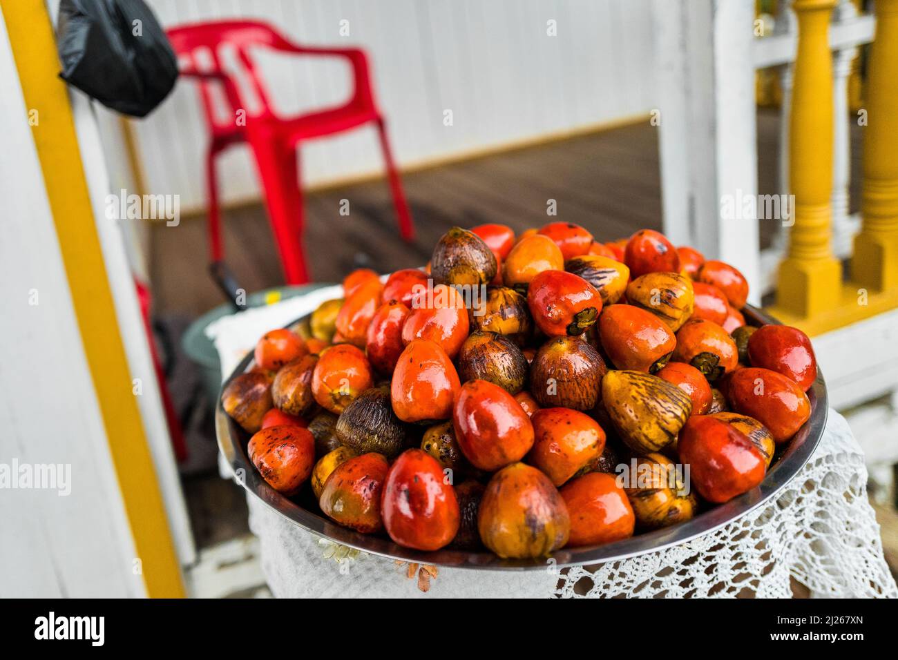 Freshly cooked chontaduro (peach palm) fruits are seen offered for sale in front of a house in Quibdó, Chocó, Colombia. Stock Photo