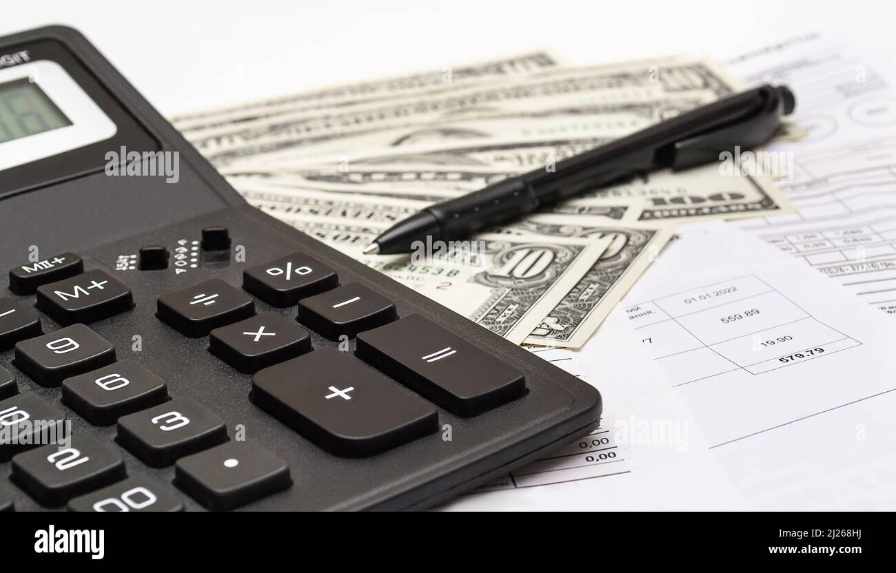 Calculator, money, pen and different bills close-up. Business, household and home budget concept Stock Photo