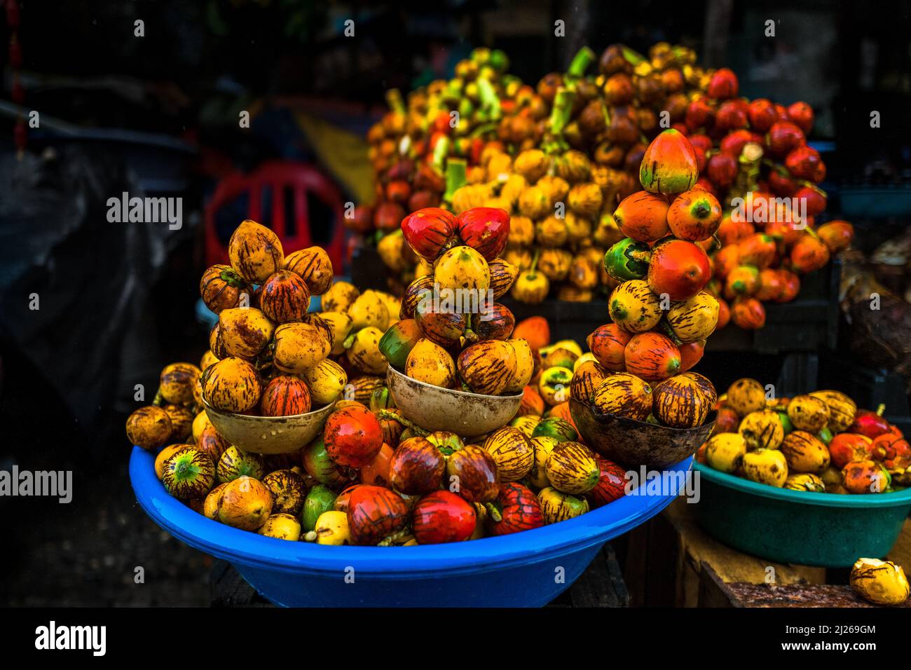 Raw chontaduro (peach palm) fruits are seen offered for sale in a street market in Quibdó, Chocó, Colombia, Stock Photo