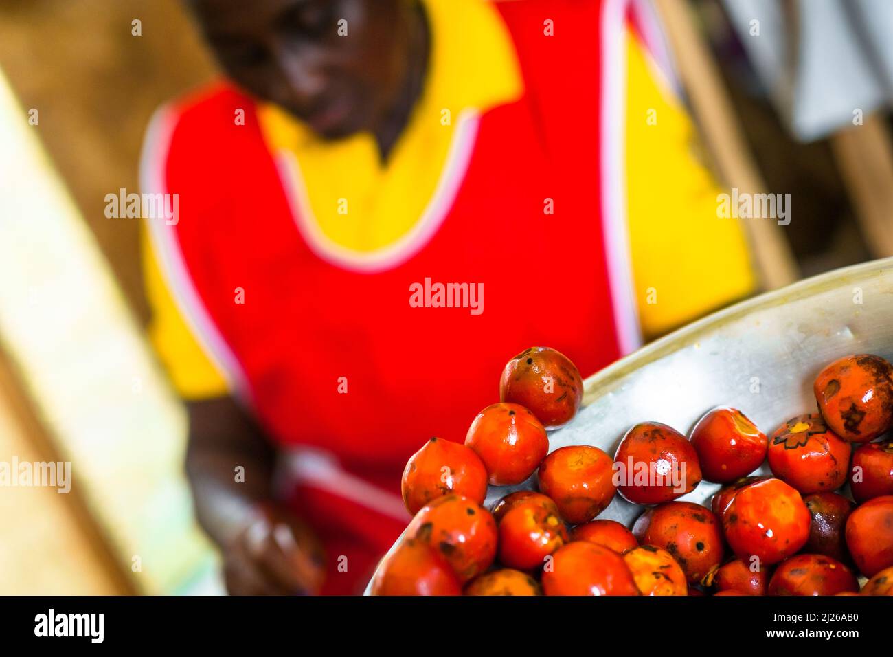 Freshly cooked chontaduro (peach palm) fruits are seen offered for sale in a street market in Cali, Valle del Cauca, Colombia. Stock Photo