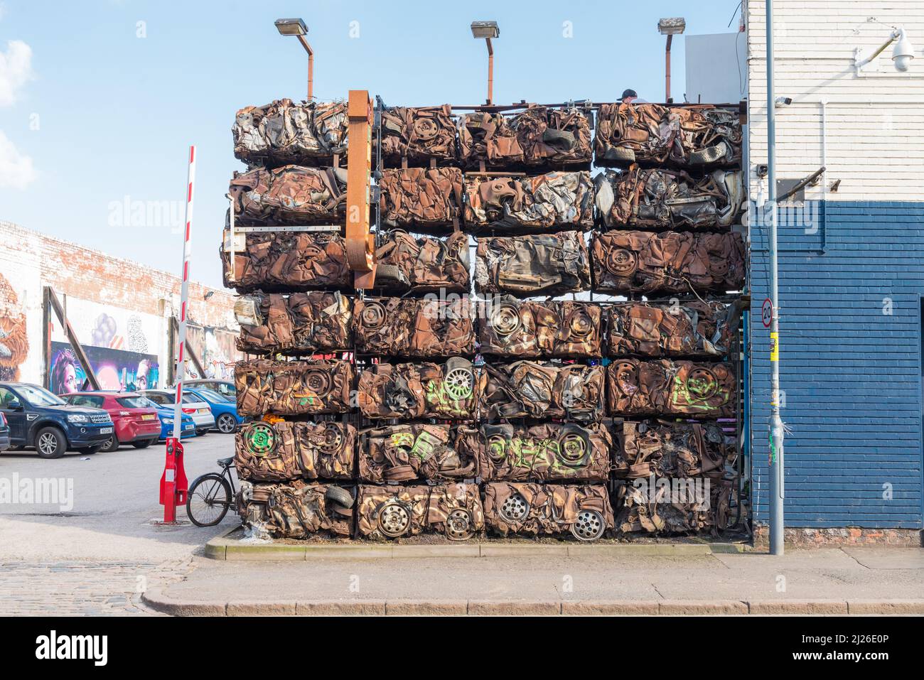 Wall made from blocks of crushed cars at entrance to car park in Digbeth, Birmingham Stock Photo
