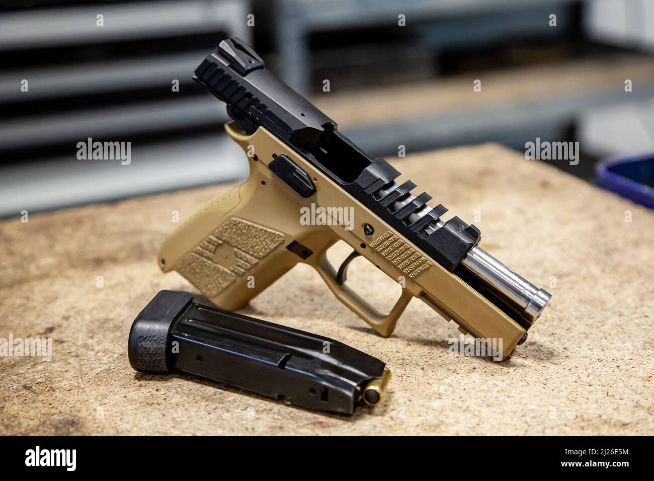 Modern traumatic pistol. Non-lethal short-barreled weapon for self-defense. Light background. Stock Photo