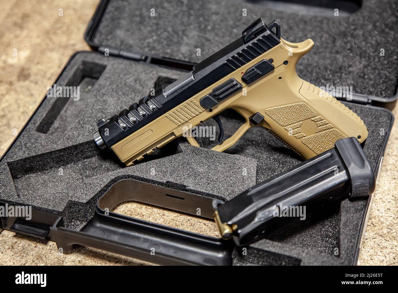 Modern traumatic pistol. Nonlethal shortbarreled weapon for selfdefense. Light background