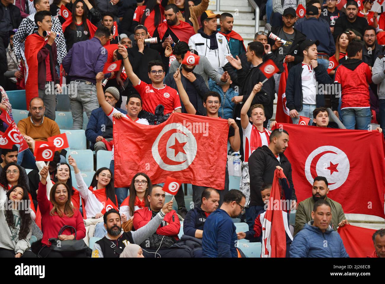 Tunis, Tunisia. 29th Mar, 2022. Tunisian supporters hold flags during the second leg of the 2022