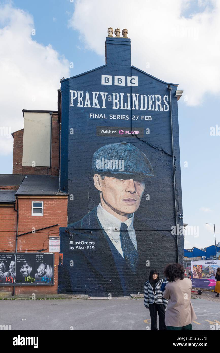 Large advert for final BBC series of Peaky Blinders featuring Cillian Murphy as Tommy Shelby painted on the wall of a building in Digbeth, Birmingham Stock Photo