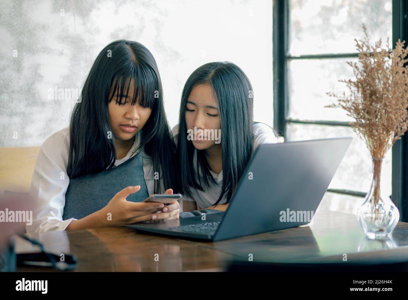 couples of asian teenager reading message in smartphone Stock Photo